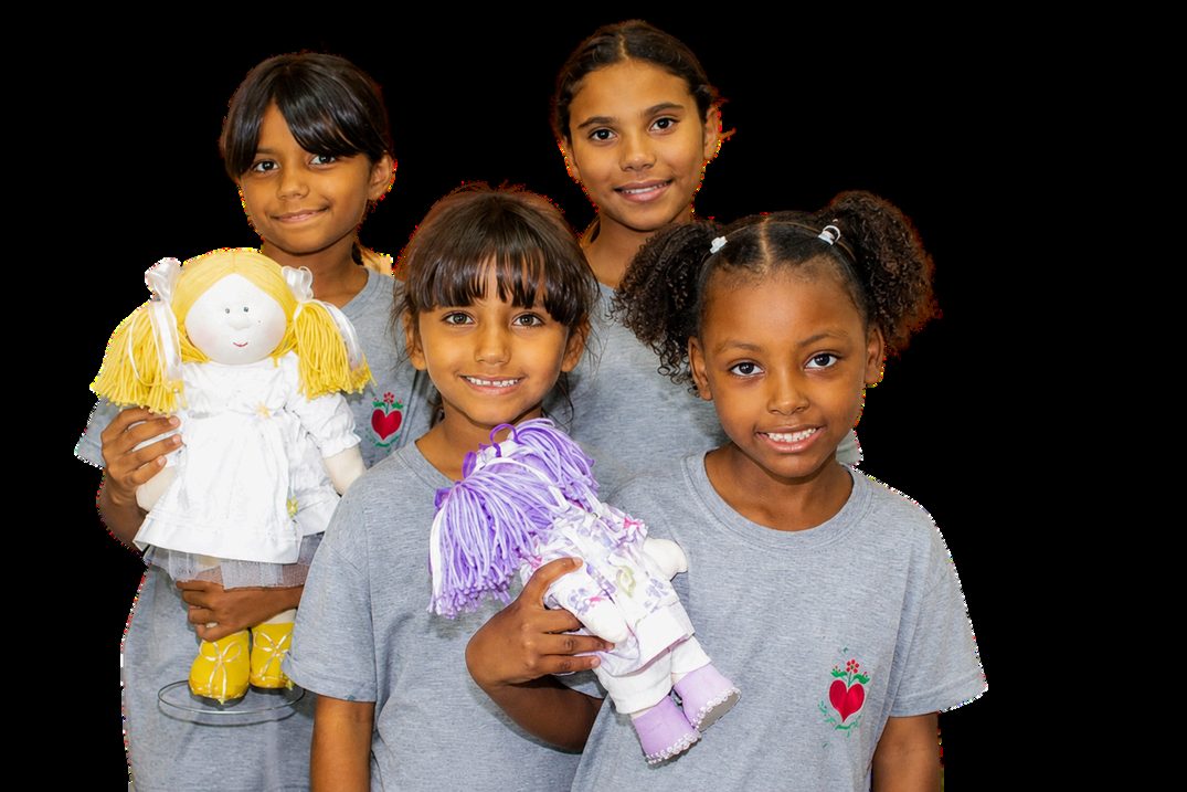 Children with dolls made from the reuse of TES Cenografia ESG fabrics